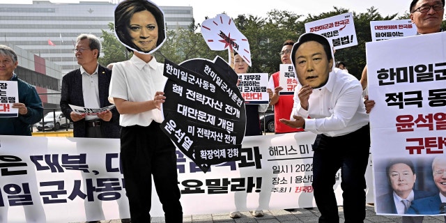 Activists wear masks showing the faces of Vice President Kamala Harris and South Korean President Yoon Suk-yeol during a protest against Harris' visit and the South Korea-US alliance, near the Presidential Office in Seoul on September 29, 2022.