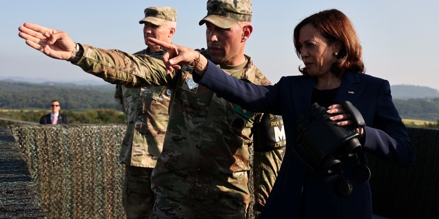 US Vice President Kamala Harris, right, looks towards the north side of the border at the Demilitarized Zone (DMZ).