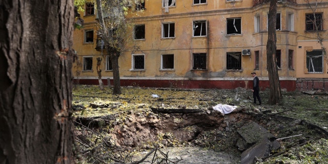 A local resident observes a crater after a missile attack in Kramatorsk, Donetsk region, on September 29, 2022, during the Russian invasion of Ukraine.