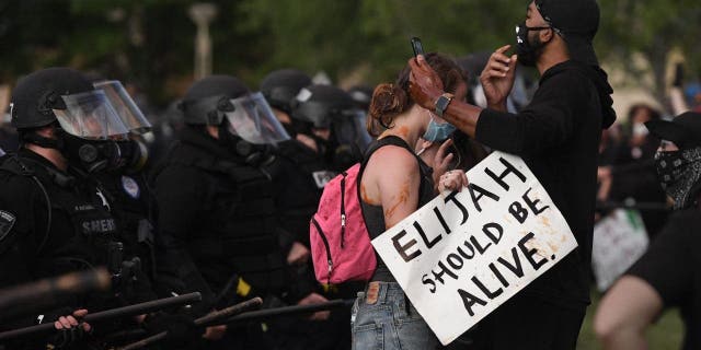 AURORA, CO - JUNE 27: Elijah McClain protesters close to the Aurora place line at the Aurora Municipal Center June 27, 2020. Elijah McClain died August 30, 2019 several days after a struggle with Aurora police. Elijah became unconscious during the encounter with police August 24, 2019 and had a heart attack while being transported to a hospital. McClain died after being taken off life support. (Photo by Andy Cross/MediaNews Group/The Denver Post via Getty Images)"n"n