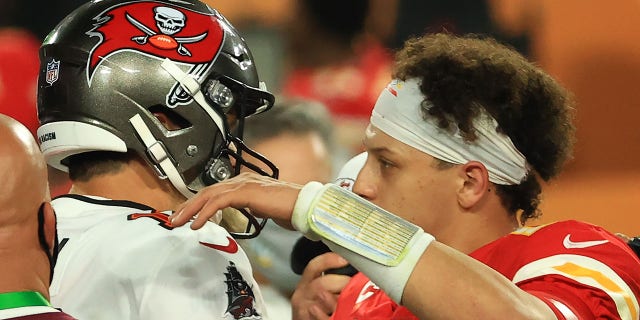 Tom Brady of the Tampa Bay Buccaneers, left, and Patrick Mahomes of the Kansas City Chiefs speak after Super Bowl LV at Raymond James Stadium Feb. 7, 2021, in Tampa, Fla. The Buccaneers defeated the Chiefs 31-9. 