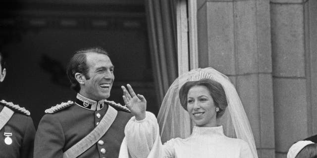 Princess Anne and Mark Phillips pose on the balcony of Buckingham Palace in London after their wedding in November 1973. They split in 1992.