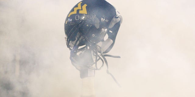A member of the West Virginia Mountaineers holds up his helmet before the take the field against the University of Pittsburgh Panthers during the 2011 Backyard Brawl on November 25, 2011, at Mountaineer Field in Morgantown, West Virginia.  