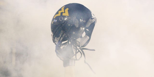 A member of the West Virginia Mountaineers holds up his helmet before the take the field against the University of Pittsburgh Panthers during the 2011 Backyard Brawl on November 25, 2011, at Mountaineer Field in Morgantown, West Virginia.  