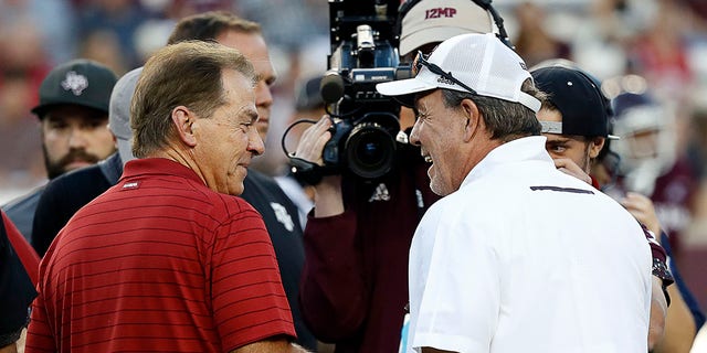 Head coach Nick Saban, of the Alabama Crimson Tide, meets with head coach Jimbo Fisher, of the Texas A&M Aggies, at Kyle Field on Oct. 9, 2021 in College Station, Texas. 