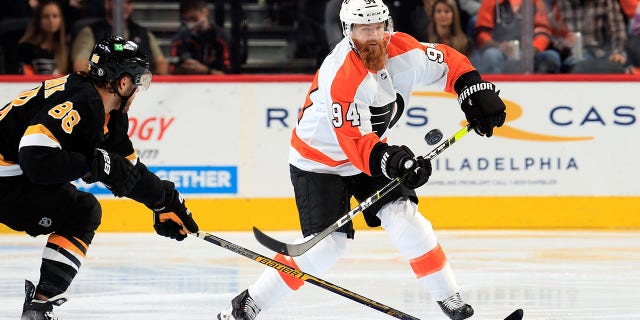 Ryan Ellis (94) of the Philadelphia Flyers attempts to break up a pass against David Pastrnak (88) of the Boston Bruins at the Wells Fargo Center Oct. 20, 2021, in Philadelphia.