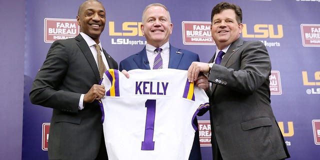 Brian Kelly, center, is introduced as the head football coach of the LSU Tigers by LSU President William F. Tate IV, left, and athletics director Scott Woodward during a news conference at Tiger Stadium Dec. 1, 2021 in Baton Rouge, La. 