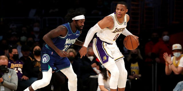 Russell Westbrook of the Lakers handles the ball against Patrick Beverley of the Minnesota Timberwolves at Crypto.com Arena on Jan. 2, 2022, in Los Angeles.