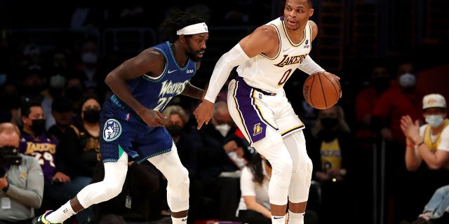 Russell Westbrook of the Lakers handles the ball against Patrick Beverley of the Minnesota Timberwolves at Crypto.com Arena on Jan. 2, 2022, in Los Angeles.