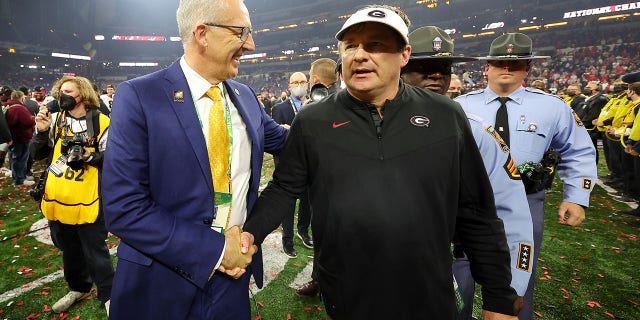 Head Coach Kirby Smart of the Georgia Bulldogs shakes hands with SEC Commissioner Greg Sankey after the Georgia Bulldogs defeated the Alabama Crimson Tide 33-18 in the 2022 CFP National Championship Game at Lucas Oil Stadium on January 10, 2022 in Indianapolis, Indiana. 