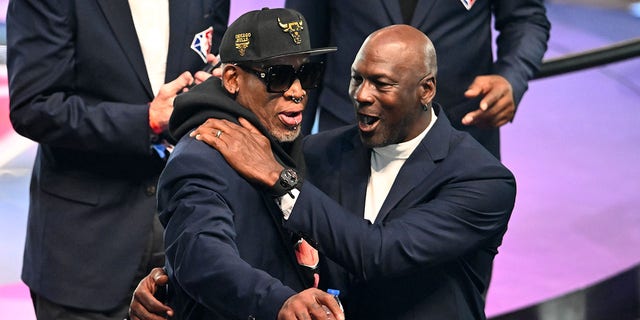 Dennis Rodman, left, and Michael Jordan pose for photos after the introduction of the NBA 75th anniversary team during the 2022 NBA All-Star Game at Rocket Mortgage Fieldhouse in Cleveland, Ohio, on Feb.  20, 2022.