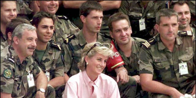 Diana, Princess of Wales, posed for a photograph with some French SFOR soldiers at Sarajevo airport before her flight to London.