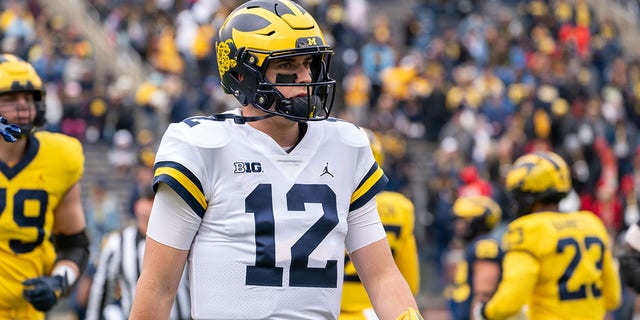 Cade McNamara of the Michigan Wolverines walks to the sideline during the spring football game at Michigan Stadium  in Ann Arbor, Michigan, on April 2, 2022.