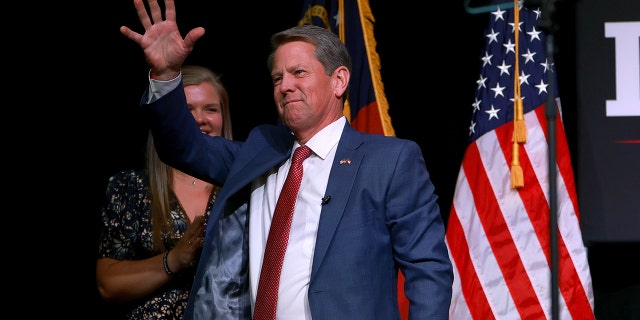 Incumbent Republican Gov.  Brian Kemp waves during his primary night election party at the Chick-fil-A College Football Hall of Fame on May 24, 2022, in Atlanta, Georgia.