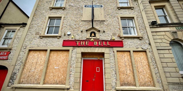 A pub, which has closed its doors to customers, has its windows boarded-up in Shepton Mallet, on July 25, 2022, in Somerset, England. Since the year 2000, a quarter of pubs have closed in the UK, totalling more than 13,000 locations.