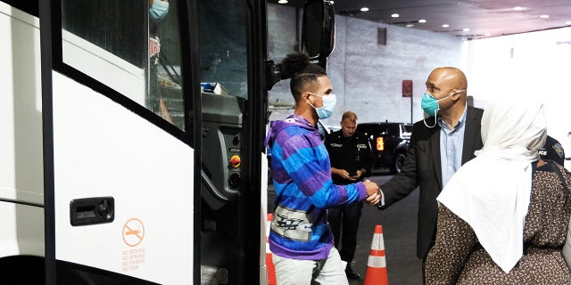 Immigrants disembark from a bus arriving at the Port Authority Bus Station in Manhattan across the border from Mexico to Texas 