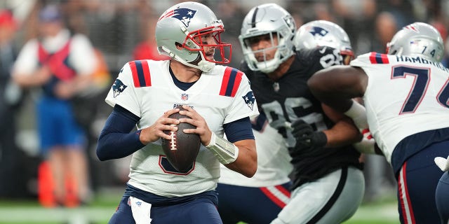 Quarterback Brian Hoyer of the New England Patriots looks to throw a pass against the Raiders at Allegiant Stadium on Aug. 26, 2022, in Las Vegas.