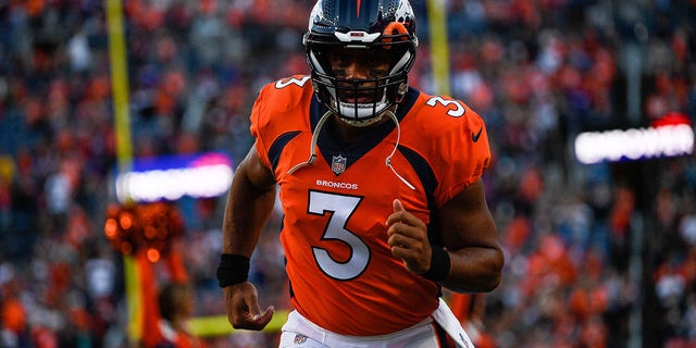 Quarterback Russell Wilson of the Denver Broncos runs onto the field before a preseason game against the Minnesota Vikings at Empower Field at Mile High Aug. 27, 2022, in Denver, Colo. 