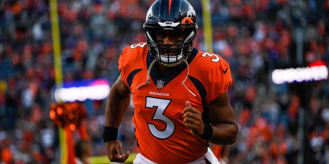 Denver Broncos quarterback Russell Wilson runs onto the field before a preseason game against the Minnesota Vikings at Empower Field at Mile High on August 27, 2022 in Denver, Colorado. 