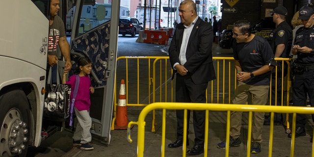 City officials greet migrants arriving on buses from Texas on August 29, 2022 at the Port Authority bus station in midtown New York City, New York. (Photo by Andrew Lichtenstein/Corbis via Getty Images)