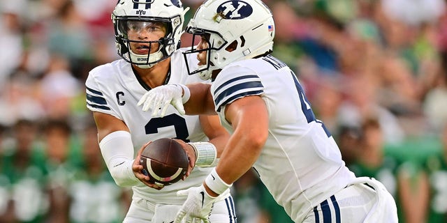 Jaren Hall (3) hands the ball off to Lopini Katoa (4) of the Brigham Young Cougars in the first quarter against the South Florida Bulls at Raymond James Stadium Sept. 3, 2022, in Tampa, Fla. 