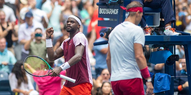 Frances Tiafoe celebrates a break of serve as Rafael Nadal returns to his seat during the U.S. Open at the USTA National Tennis Centre on Sept. 5 2022, in Queens, New York City.