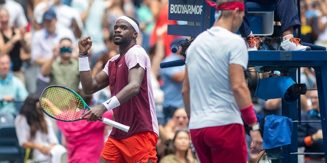 Frances Tiafoe celebrates a break of serve as Rafael Nadal returns to his seat during the U.S. Open at the USTA National Tennis Centre on Sept. 5 2022, in Queens, New York City.