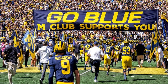 Michigan Wolverines players take the field before a game against the Colorado State Rams at Michigan Stadium Sept. 3, 2022, in Ann Arbor, Mich. 