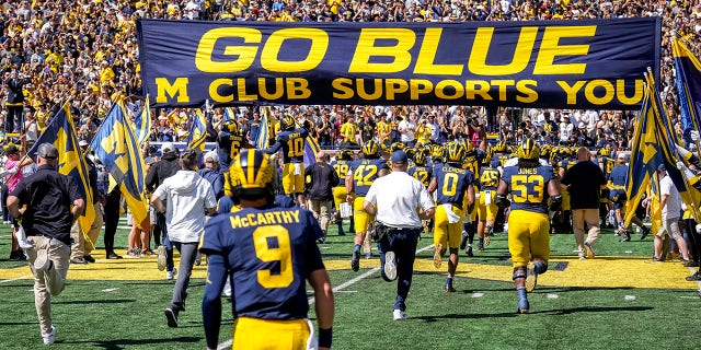 Michigan Wolverines players take the field before a game against the Colorado State Rams at Michigan Stadium Sept. 3, 2022, in Ann Arbor, Mich.