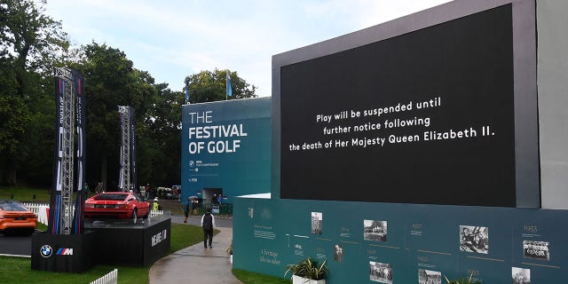 A screen shows the announcement that play will be suspended following the death of Her Majesty Queen Elizabeth II during the BMW PGA Championship on September 8, 2022 at Wentworth Golf Club in Virginia Water, England.