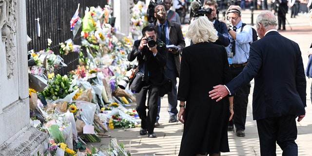 King Charles III and Camilla, Queen Consort view floral tributes to the late Queen Elizabeth II.