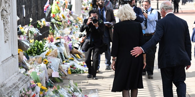 King Charles III and Camilla, Queen Consort view floral tributes to the late Queen Elizabeth II.