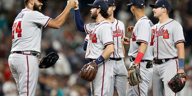 Kenley Jansen, 74, of the Atlanta Braves celebrates the finals against his teammates in a 6-4 victory over the Seattle Mariners at T-Mobile Park in Seattle on Sept. 9, 2022. 