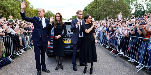 Kate Middleton, Prince William, Prince of Wales, Prince Harry, Duke of Sussex and Meghan, Duchess of Sussex wave to a crowd on the Long Promenade of Windsor Castle on September 10, 2022 in Windsor, England. 