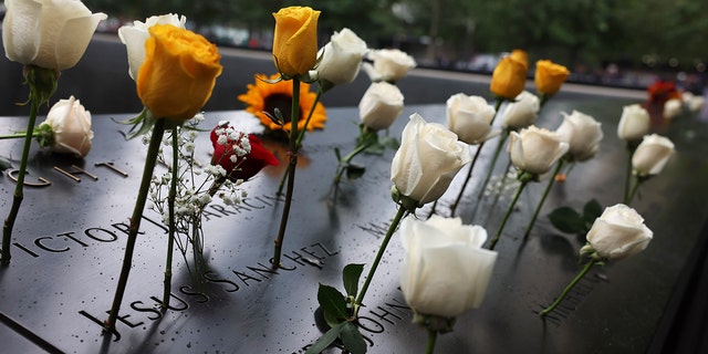 Flowers are seen in the names of the victims of the 9/11 attacks at the North Tower Memorial Pool during the 9/11 memorial ceremony held at the National 9/11 Memorial and Museum in New York City on September 11, 2022 .