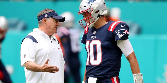 Head coach Bill Belichick and Mac Jones during pregame at Hard Rock Stadium on September 11, 2022 in Miami Gardens, Florida. 