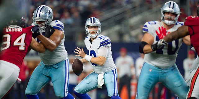 Cooper Rush of the Dallas Cowboys walks back to pass against the Tampa Bay Buccaneers on September 11, 2022 in Arlington, Texas.