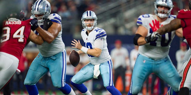 Cooper Rush of the Dallas Cowboys walks back to pass against the Tampa Bay Buccaneers on September 11, 2022 in Arlington, Texas.