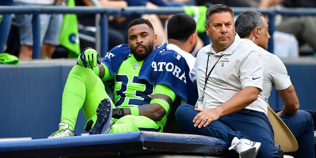 Jamal Adams, #33 of the Seattle Seahawks, is carted off the field during the second quarter against the Denver Broncos at Lumen Field on Sept. 12, 2022 in Seattle. 