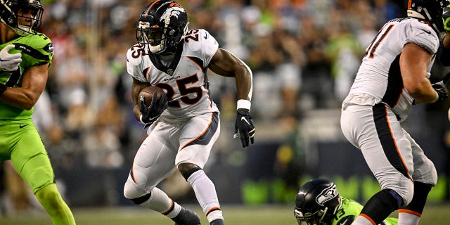 Melvin Gordon III (25) of the Denver Broncos runs with the ball against the Seattle Seahawks during the second half of Seattle's 17-16 win at Lumen Field Monday, Sept. 12, 2022.