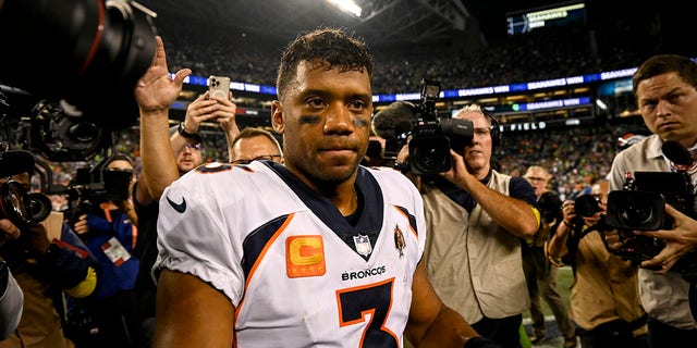 Russell Wilson of the Denver Broncos prepares to shake hands with Seahawks head coach Pete Carroll after losing to Seattle 17-16 on Monday, Sept. 12, 2022.