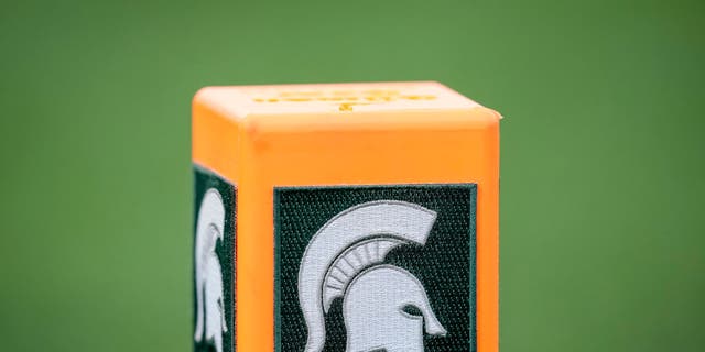 The Michigan State Spartans logo is pictured on a pylon during the game against the Akron Zips. Michigan State University's president acknowledged a "moment of uncertainty" on campus.