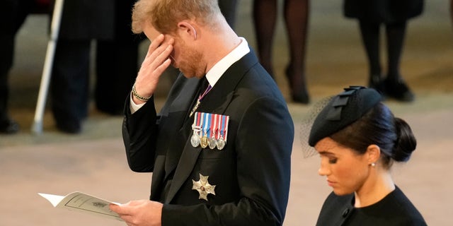 An emotional Prince Harry and Meghan pay their respects in the Palace of Westminster after the procession for the lying-in-state of Queen Elizabeth II on Sept. 14, 2022.