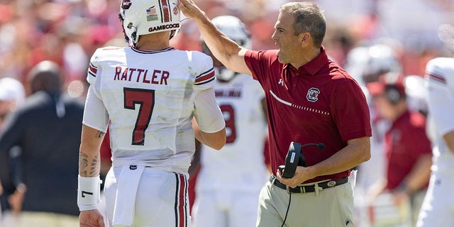 Head Coach Shane Beamer speaks with South Carolina Gamecocks' Spencer Rattler during the Arkansas Razorbacks' game on Sept. 10, 2022 in Fayetteville.