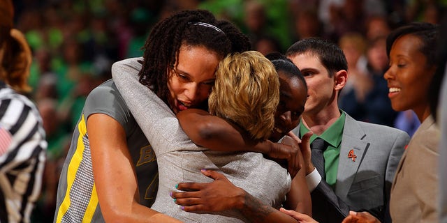 Brittney Griner #42 (L) and Jordan Madden (R) #3 of the Baylor Bears hug head coach Kim Mulkey after they won 80-61 against the Notre Dame Fighting Irish during the National Final game of the 2012 NCAA Division I Women's Basketball Championship at Pepsi Center on April 3, 2012 in Denver, Colorado.  