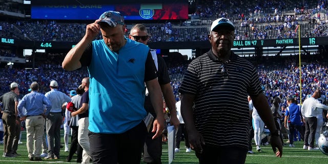 Head coach Matt Rhule, left, of the Carolina Panthers walks off the field after the game against the New York Giants at MetLife Stadium in East Rutherford, New Jersey, on Sept. 18, 2022.