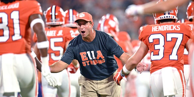 Head coach Dabo Swinney of the Clemson Tigers greets his players as they take the field before their game against the Louisiana Tech Bulldogs at Memorial Stadium on Sept. 17, 2022 in Clemson, South Carolina. 