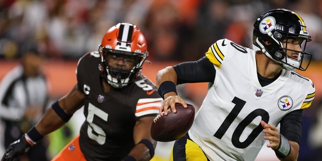 Mitch Trubisky of the Pittsburgh Steelers scrambles from Anthony Walker Jr. of the Cleveland Browns during the first quarter at FirstEnergy Stadium in Cleveland on Sept. 22, 2022.
