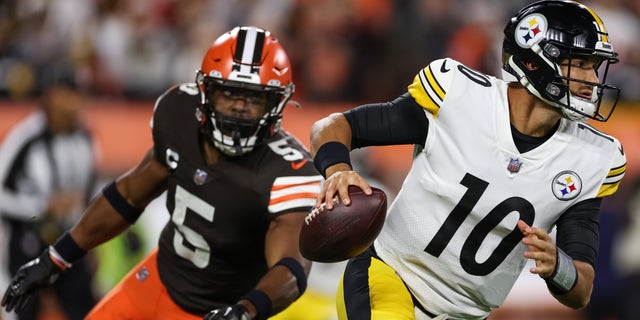 Mitch Trubisky of the Pittsburgh Steelers scrambles from Anthony Walker Jr. of the Cleveland Browns during the first quarter at FirstEnergy Stadium in Cleveland on Sept. 22, 2022.