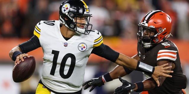 Mitch Trubisky, #10 of the Pittsburgh Steelers, scrambles from Anthony Walker Jr., #5 of the Cleveland Browns, during the first quarter at FirstEnergy Stadium on Sept. 22, 2022 in Cleveland.